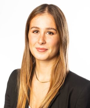 Profile image of a female with long hair. She is smiling and wearing a black jacket and a necklace.